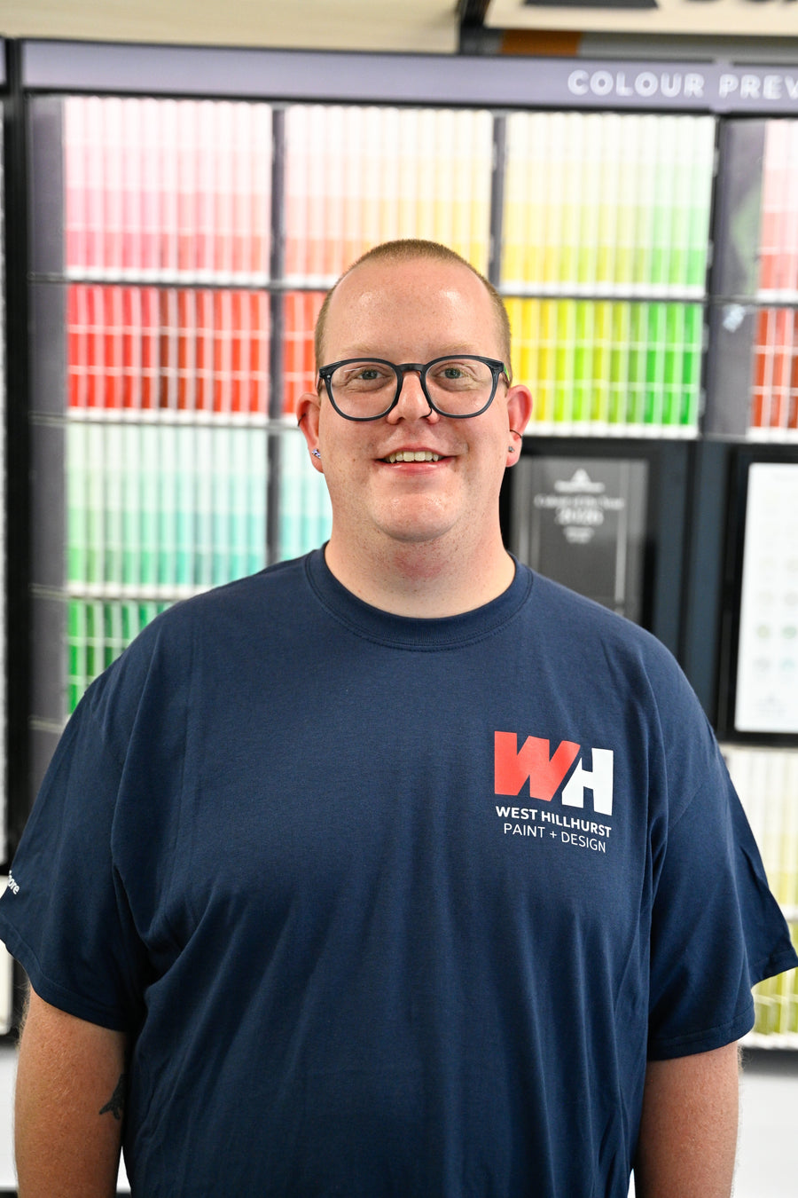 Nick Gehring, ICCP, colour consultant at West Hillhurst Paint & Design, standing at the Benjamin Moore colour wall